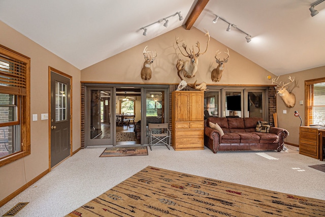 carpeted living room featuring vaulted ceiling with beams and rail lighting