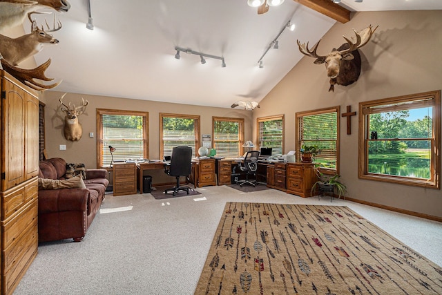 carpeted office space featuring beamed ceiling, rail lighting, and high vaulted ceiling