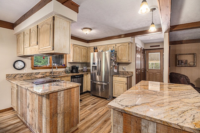 kitchen with light stone counters, stainless steel appliances, light brown cabinets, decorative light fixtures, and light hardwood / wood-style flooring