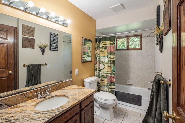 full bathroom with a textured ceiling, vanity, shower / bathtub combination with curtain, tile patterned flooring, and toilet