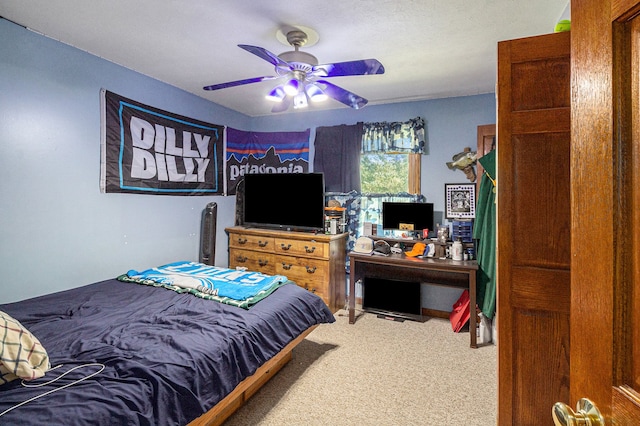 carpeted bedroom with a textured ceiling and ceiling fan