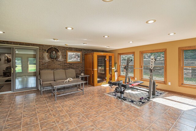 10133 W Allen Rd, Fowlerville, MI 48836 - workout area featuring recessed lighting, brick wall, and a textured ceiling