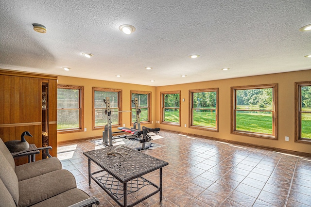 tiled living room with plenty of natural light and a textured ceiling