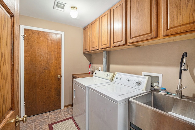 laundry room featuring washer and clothes dryer, cabinets, and sink