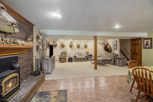 carpeted living room with a wood stove and a textured ceiling