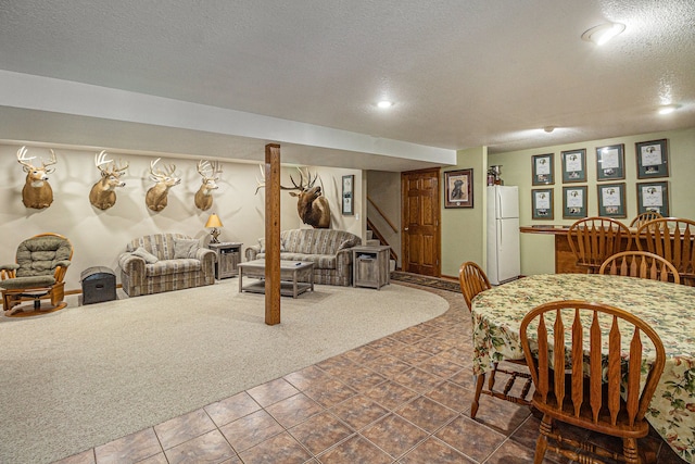 10133 W Allen Rd, Fowlerville, MI 48836 - tiled dining area featuring a textured ceiling, stairs, and recessed lighting