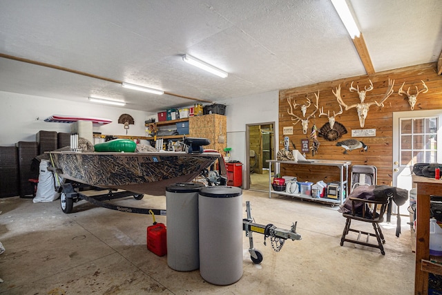 garage with a workshop area and wood walls