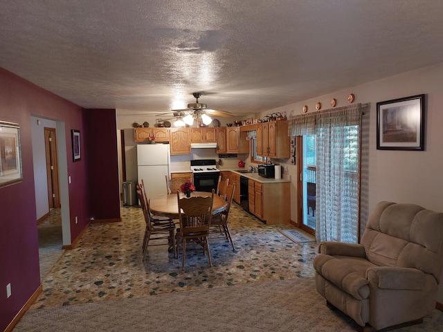 dining area featuring a textured ceiling, light colored carpet, ceiling fan, and sink