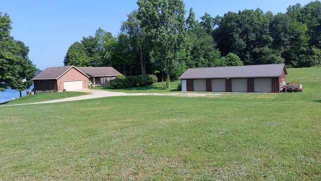 view of yard featuring an outbuilding and a garage