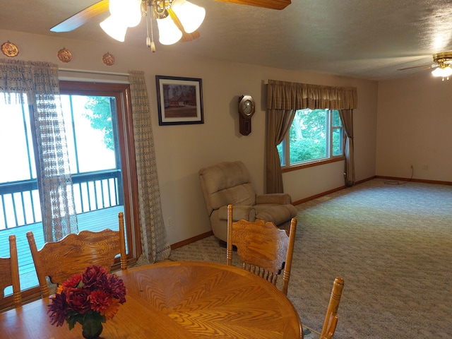 dining room featuring plenty of natural light, ceiling fan, and carpet floors