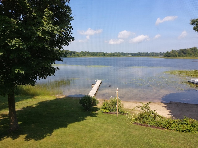 view of dock featuring a water view and a lawn