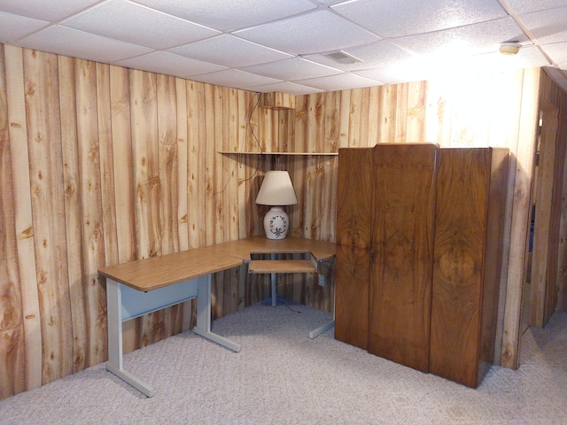 interior space featuring a paneled ceiling and carpet