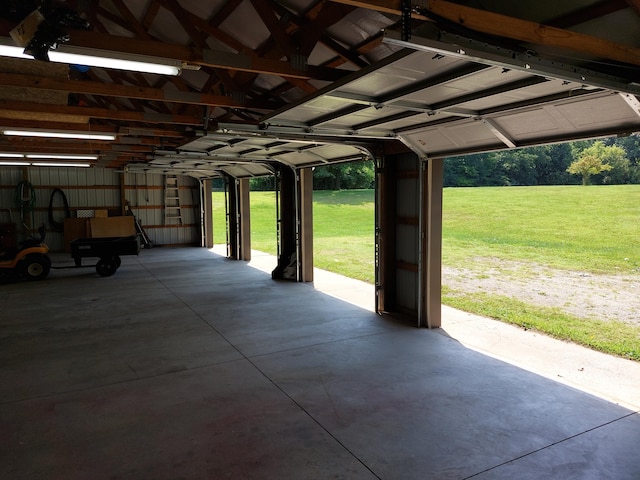 garage featuring a yard and a carport