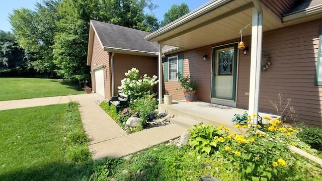 property entrance with a garage and a yard