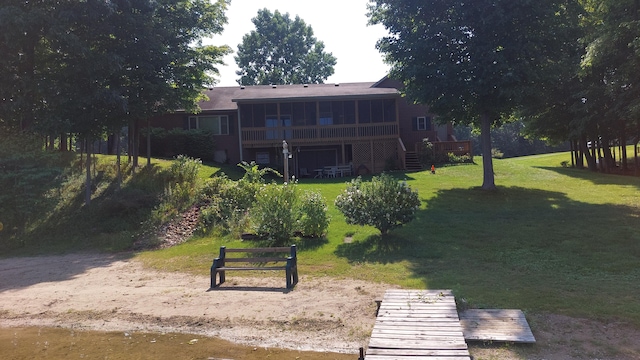 view of property's community with a wooden deck and a yard