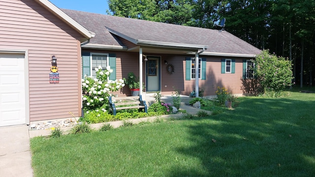 single story home featuring a front lawn and a garage