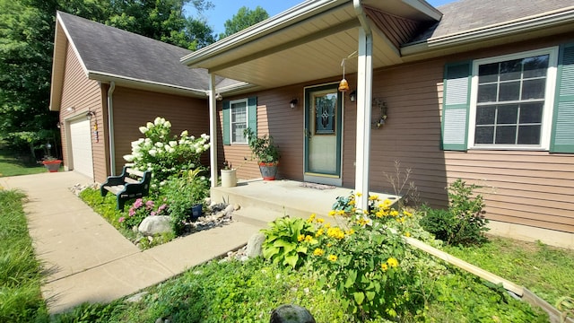 doorway to property with a garage