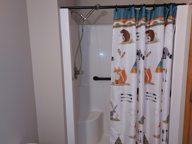 bathroom featuring a shower with curtain