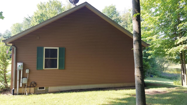 view of side of home with a yard