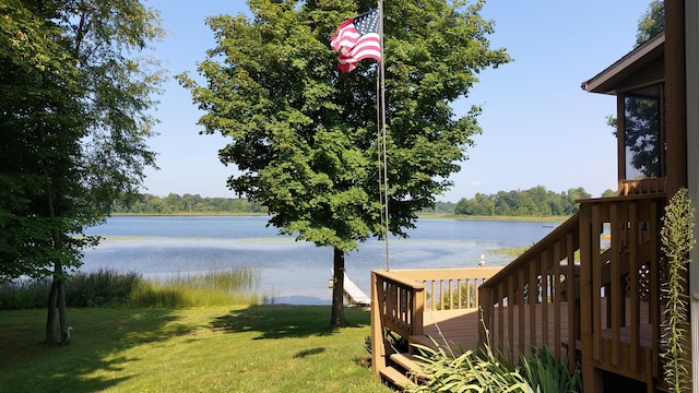 view of yard with a deck with water view