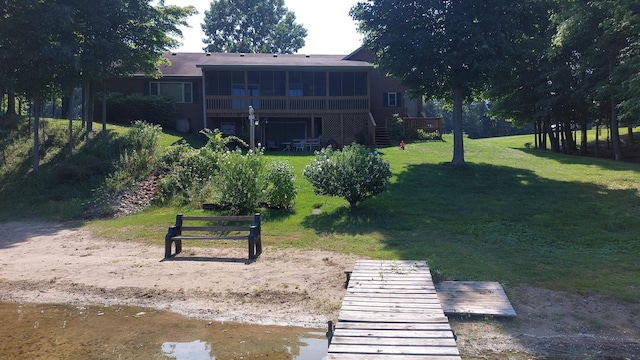 view of home's community with a wooden deck and a yard