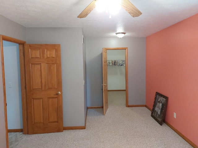 interior space featuring light carpet and a textured ceiling