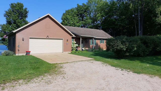 single story home featuring a garage and a front yard