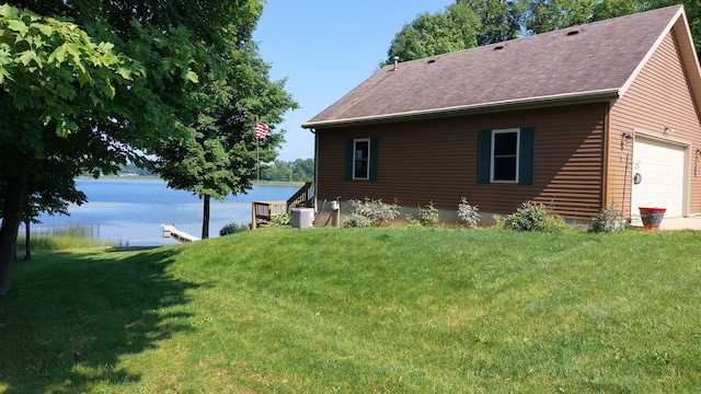 view of property exterior featuring cooling unit, a yard, and a water view