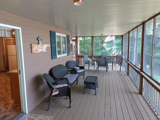 sunroom / solarium featuring an inviting chandelier