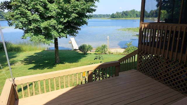 deck with a yard and a water view