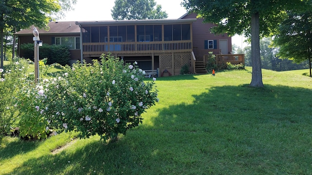 view of yard with a sunroom and a deck