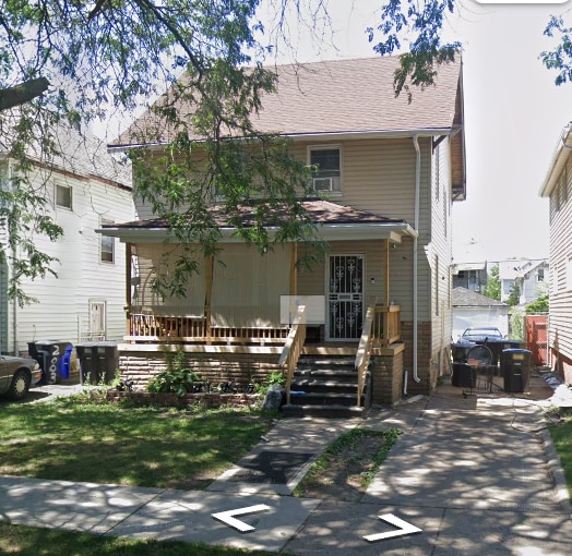 view of front of property with a front yard and a porch