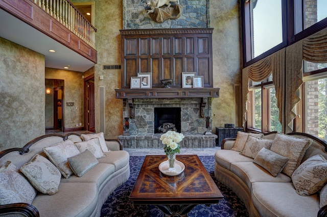 living room featuring a fireplace and a high ceiling