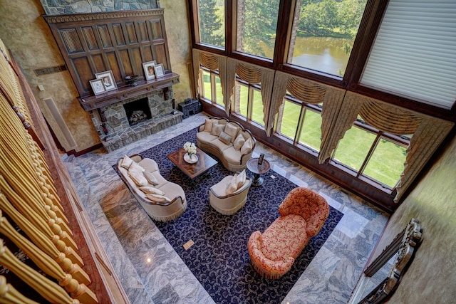 living room featuring a fireplace and a water view