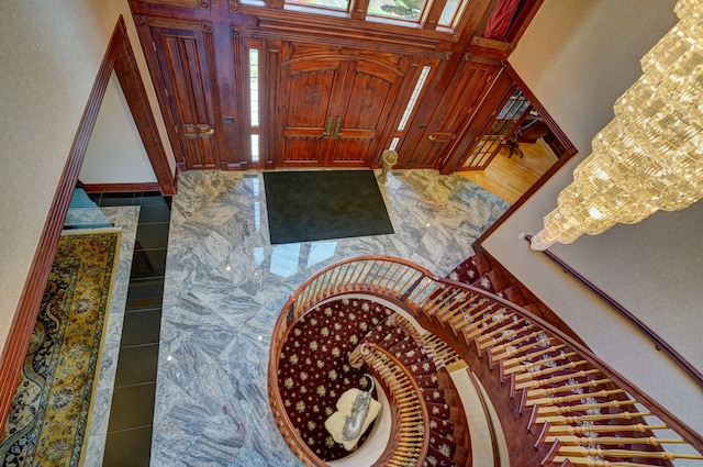 entryway featuring wooden walls and an inviting chandelier