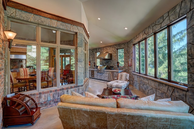 sunroom / solarium featuring plenty of natural light and lofted ceiling