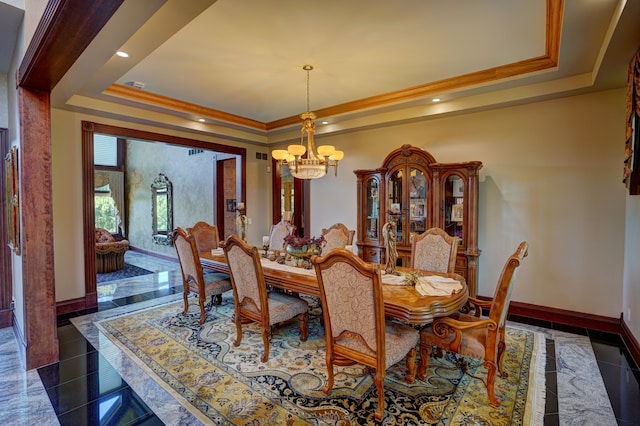 dining area with a raised ceiling, crown molding, and an inviting chandelier