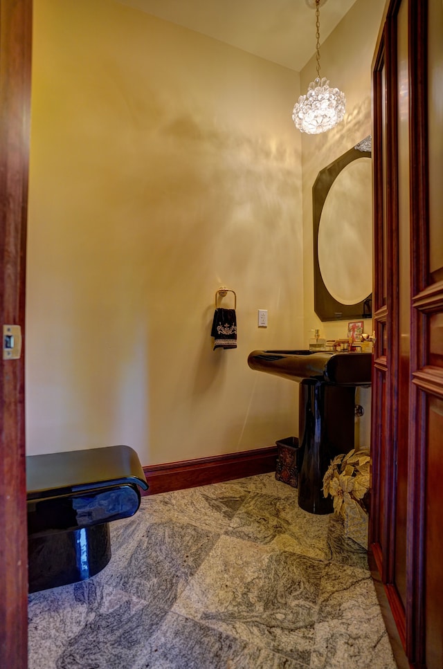 bathroom with vanity and a notable chandelier