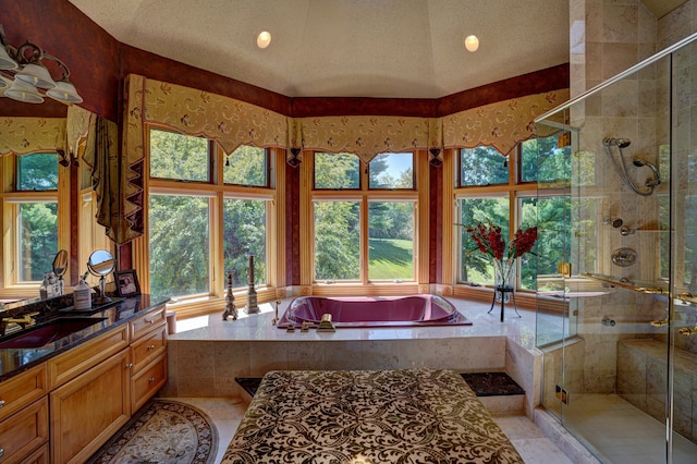 bathroom featuring a textured ceiling, vanity, separate shower and tub, vaulted ceiling, and tile patterned flooring