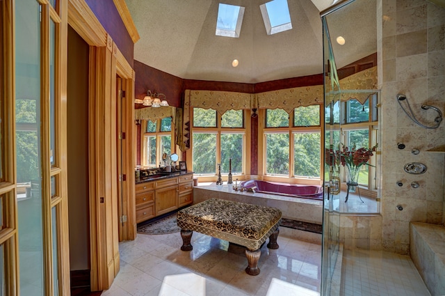 bathroom with vanity, lofted ceiling with skylight, a textured ceiling, and independent shower and bath