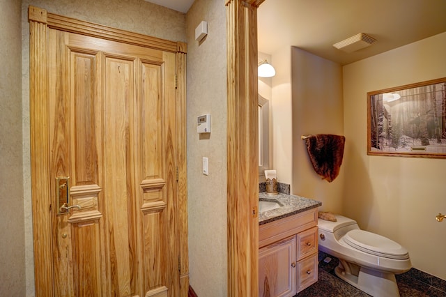 bathroom featuring tile patterned flooring, vanity, and toilet