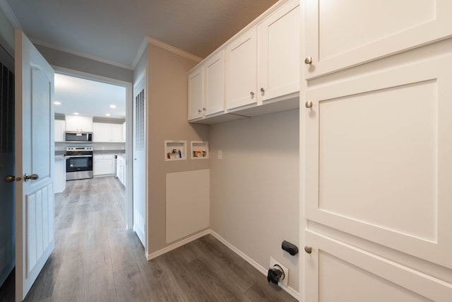 2776 Pinellas Ct, Lapeer, MI 48446 - washroom with crown molding, hookup for a washing machine, dark wood-style flooring, recessed lighting, and cabinet space