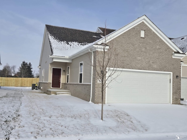 view of front facade with a garage and central AC unit