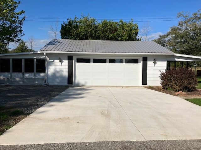 7377 Birch Dr, Port Hope, MI 48468 - garage featuring driveway