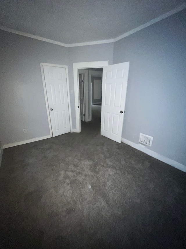 carpeted spare room with crown molding and a textured ceiling