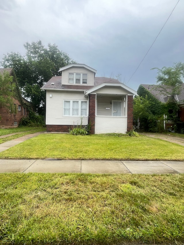 bungalow-style home featuring a front yard