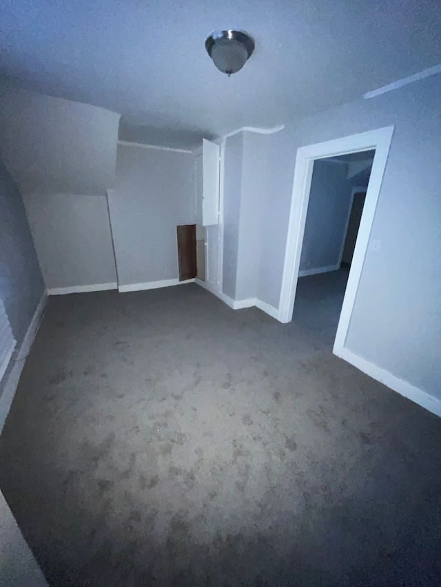 bonus room featuring dark colored carpet