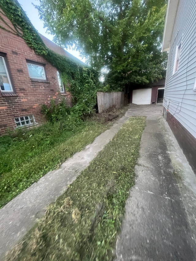 view of yard with a garage and an outdoor structure