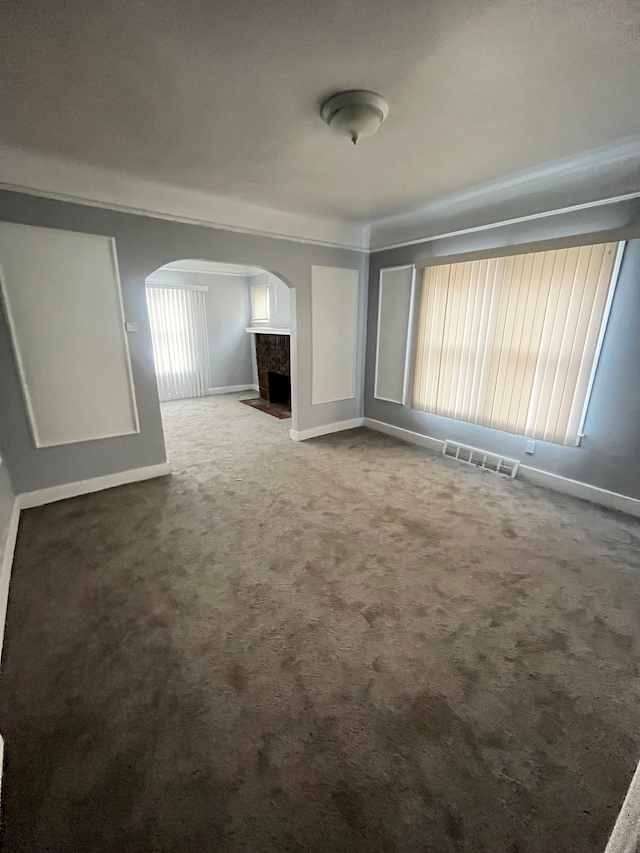 unfurnished living room with carpet floors and a premium fireplace