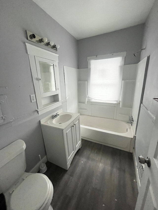 full bathroom with hardwood / wood-style floors, vanity, toilet, and shower / bathtub combination